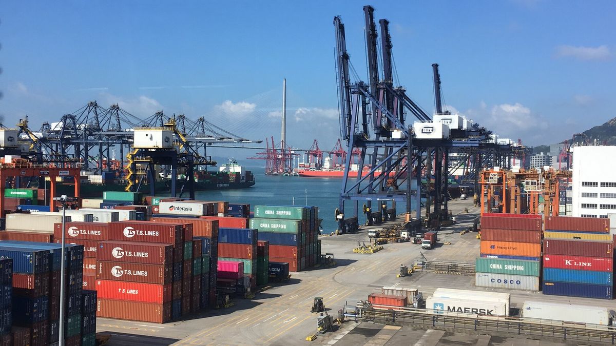 Stacked shipping containers and gantry cranes at a container terminal in Kwai Chung, Hong Kong