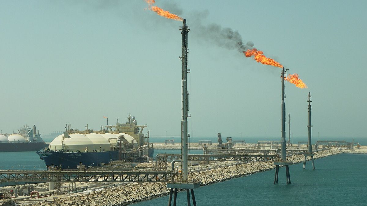 Gas flares and an LNG tanker at the jetty of the Ras Laffan terminal in Qatar